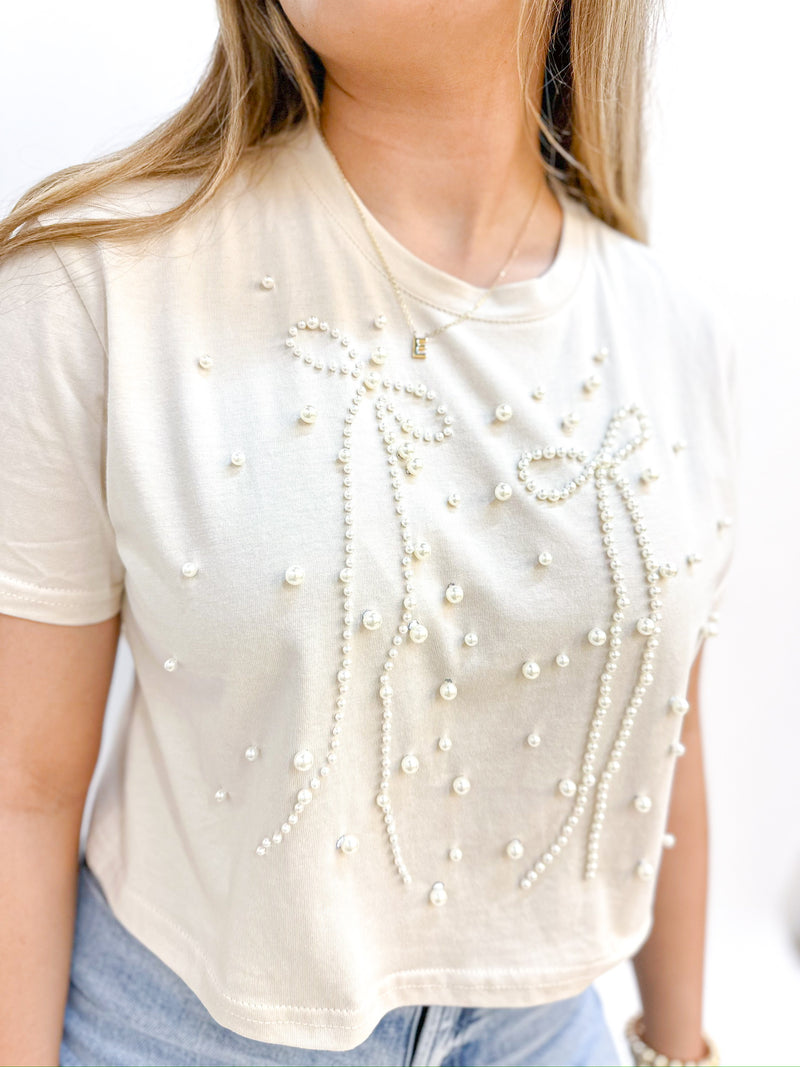 cropped white top with pearl embellishments