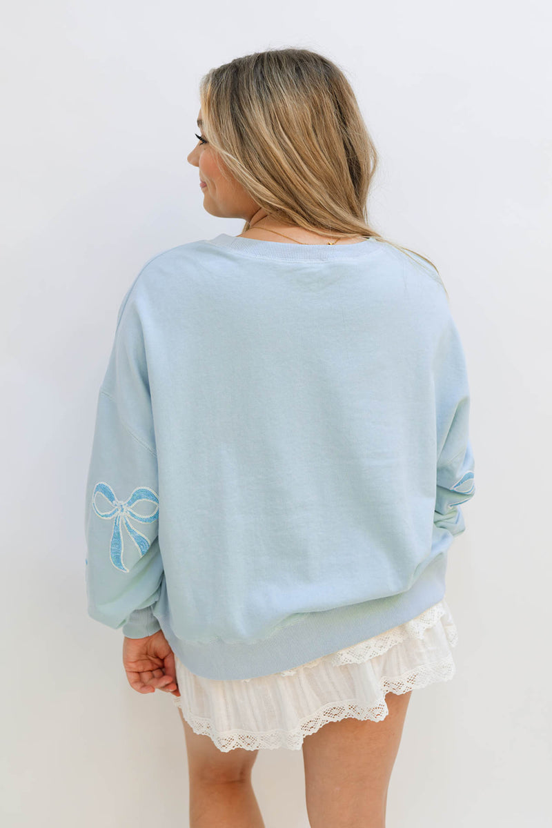 blue sweatshirt with bows 