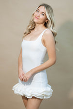 White bodycon mini dress with ruffle hem