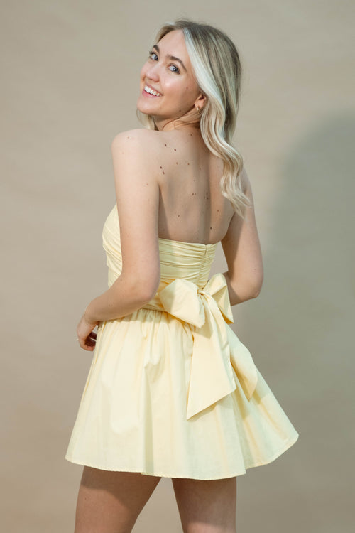 Yellow strapless mini dress with bow back