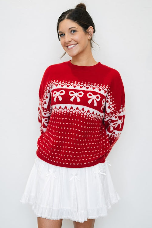 red fair isle sweater with ivory bow pattern
