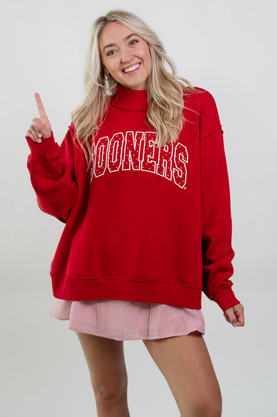 Officially licensed Oklahoma Sooners red sweatshirt with oversized fit.