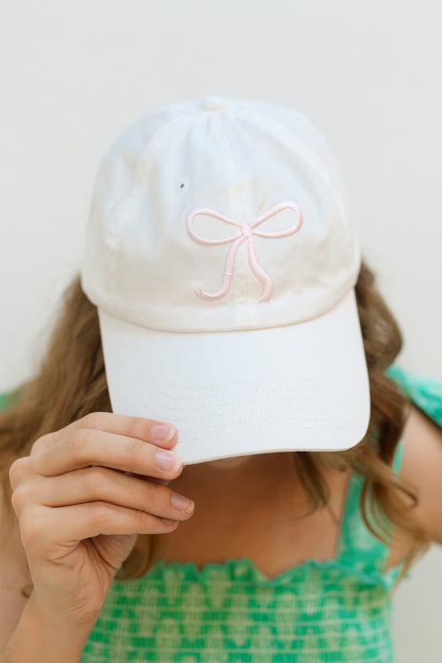 Adjustable white cap with ribbon detail