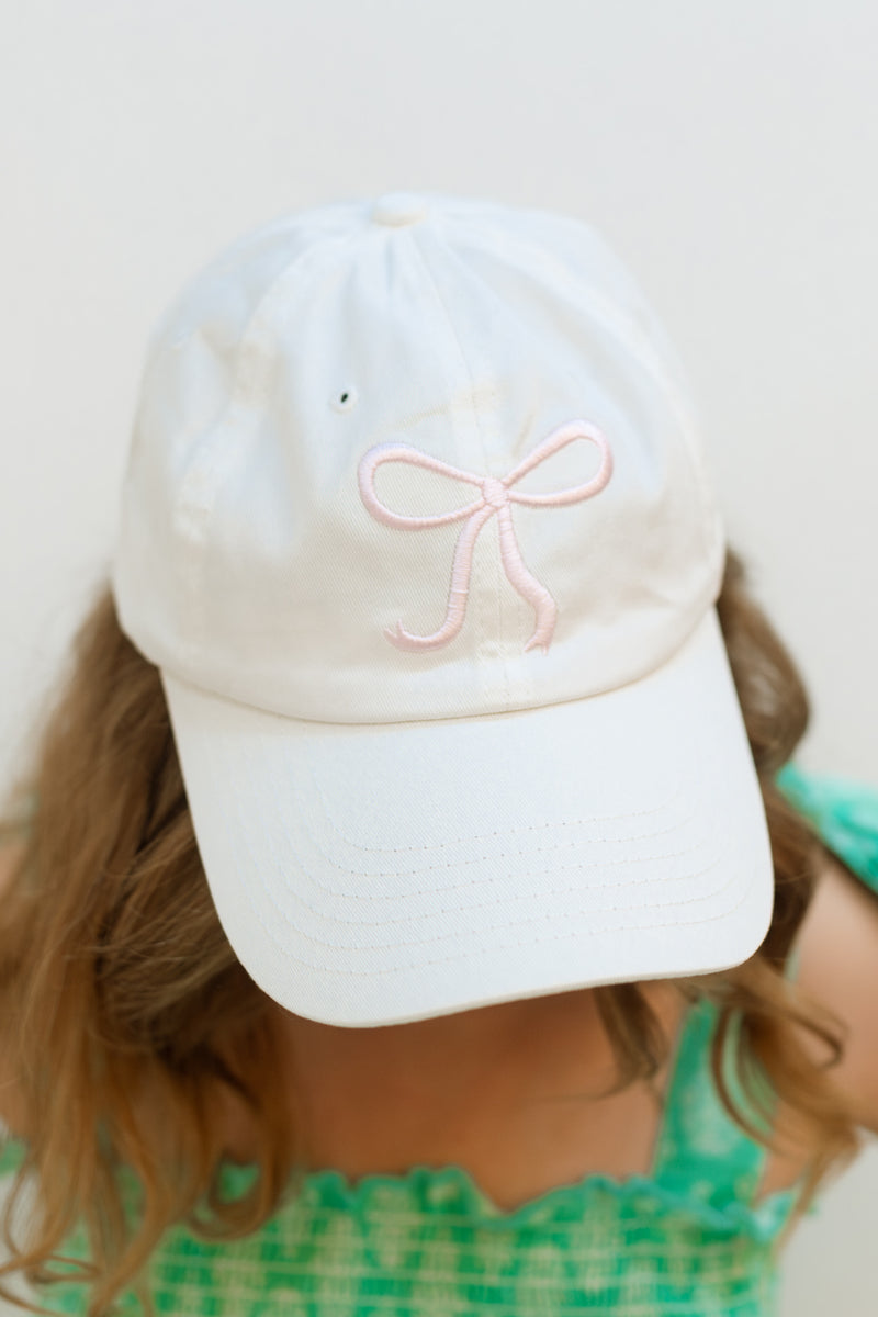 White cap with pink ribbon embroidery