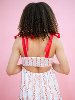 Open back dress with red bow ties