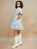 White spring dress with blue trim and pockets