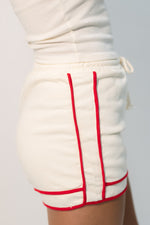 Sporty cream shorts red trim detail