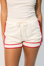 Cream shorts with red piping contrast trim shorts