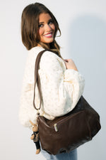 Brown leather bag styled with teddy bear charms