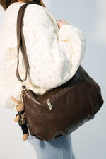 Quiet luxury chocolate brown handbag with accessories