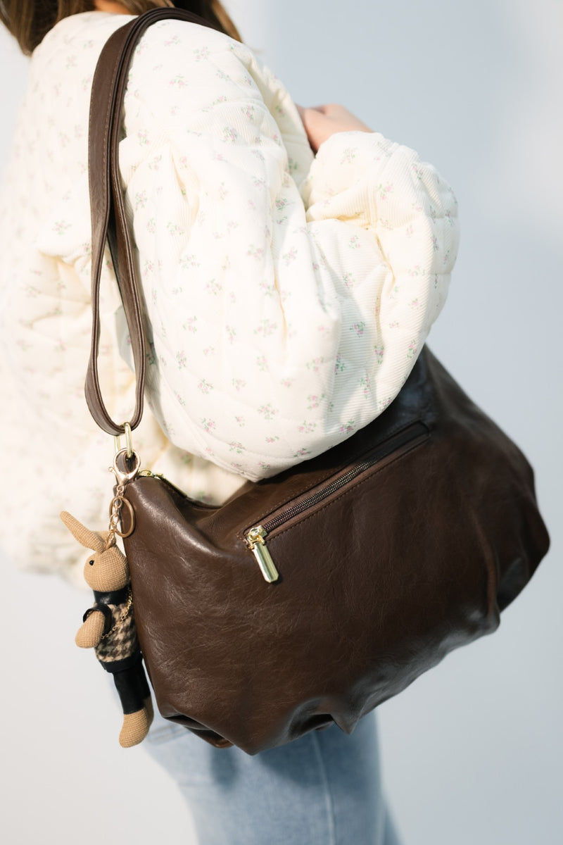 Quiet luxury chocolate brown handbag with accessories