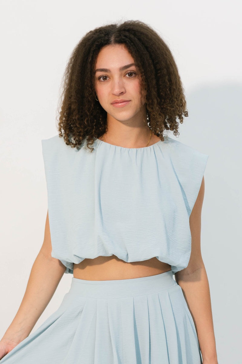 Light blue sleeveless blouse with back tie detail