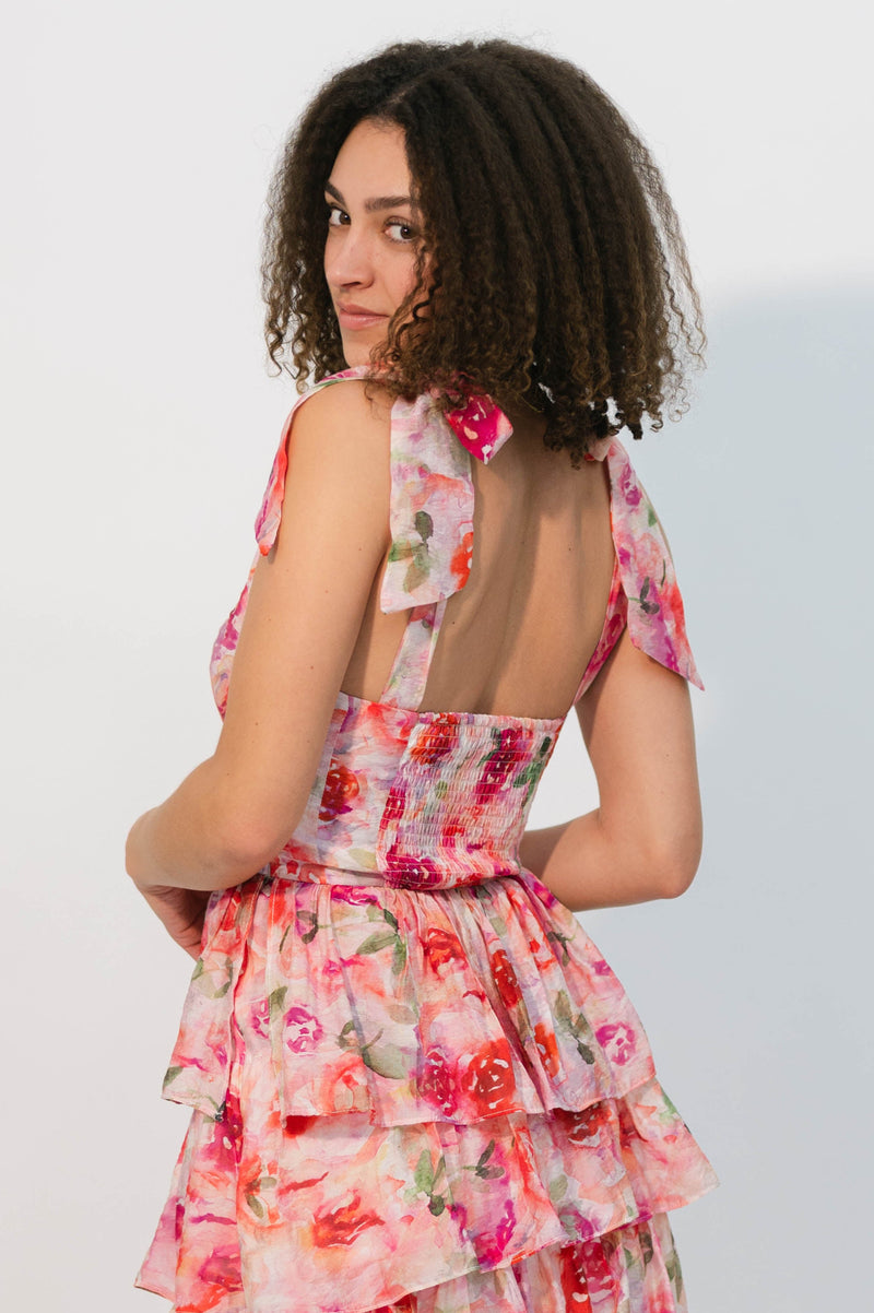 Multi-tiered pink floral midi dress with smocked backing