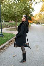 Elegant black coat with faux fur accents